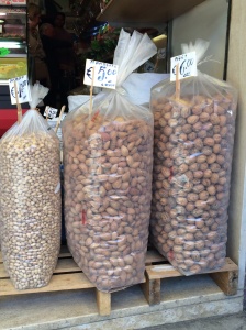 Large bags of almonds and pistachios. 