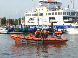 Royal Coast Guard off to an emergency in front of Isle of Wight ferry 
